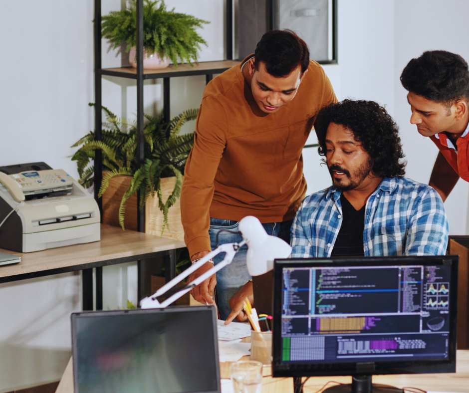 Infodecimal team meeting on end-to-end testing process for software quality assurance